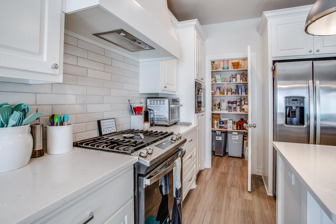 5701 119th Street Lubbock, TX 79424 - Photo 9 of 22 a kitchen with stainless steel appliances a white stove top oven a counter space and cabinets