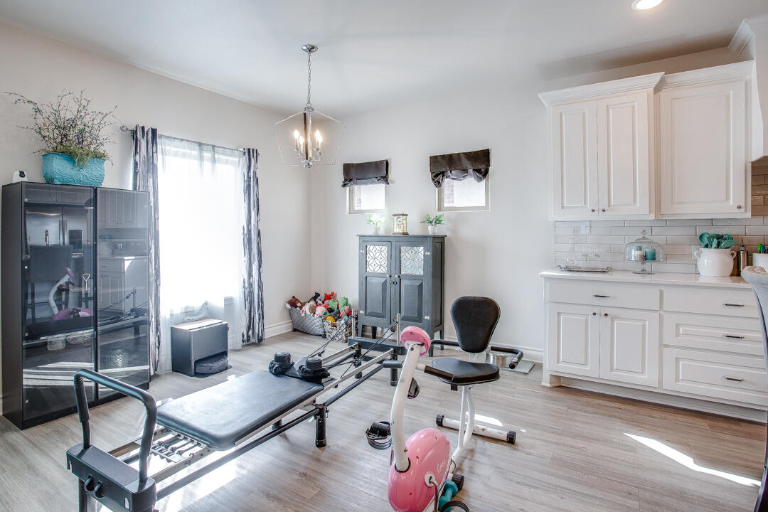 5701 119th Street Lubbock, TX 79424 - Photo 10 of 22 a living room with furniture or wooden floor and a chandelier