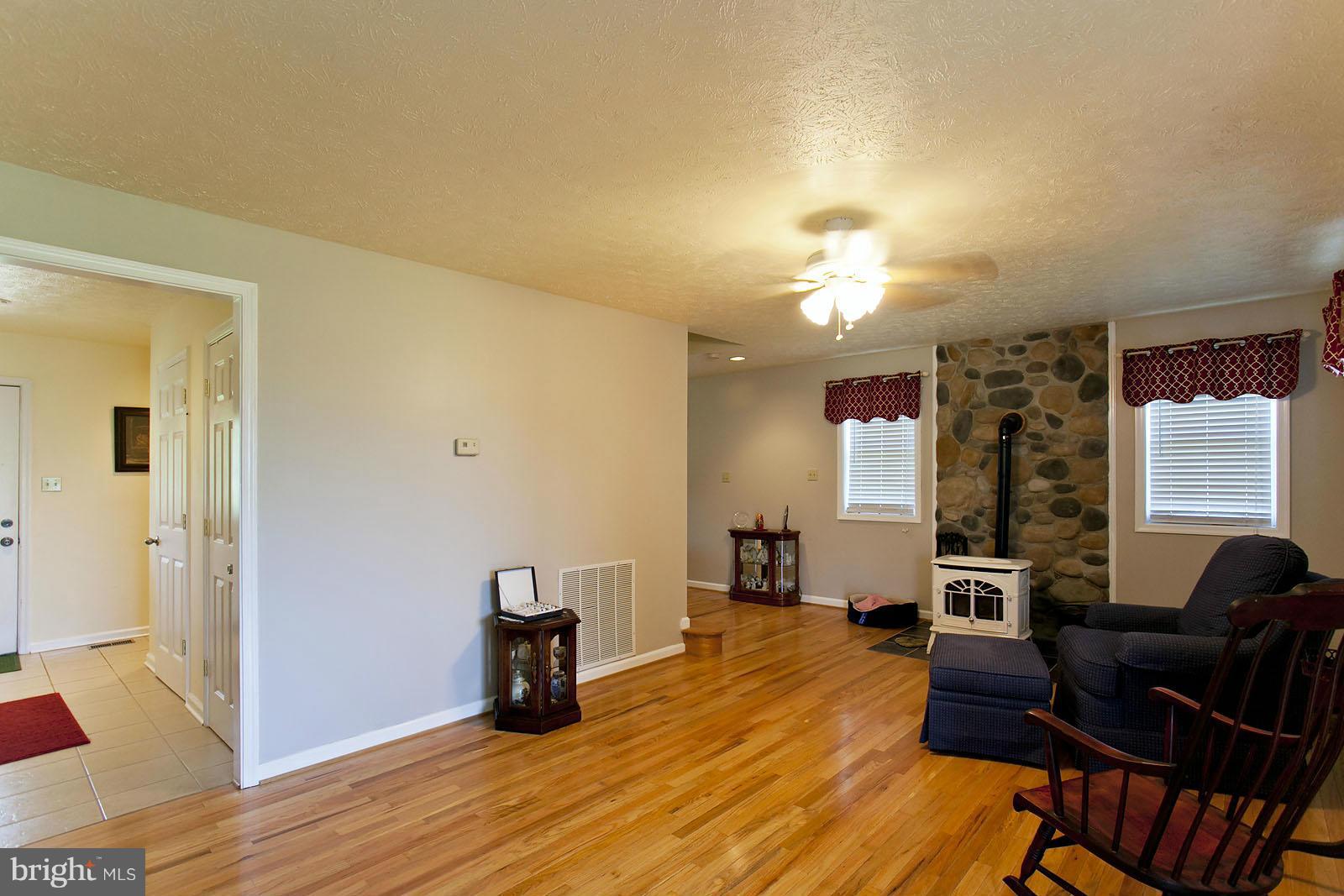 1209 Hollow Road Gore, VA 22637 - Photo 12 of 30 a living room with furniture and a wooden floor