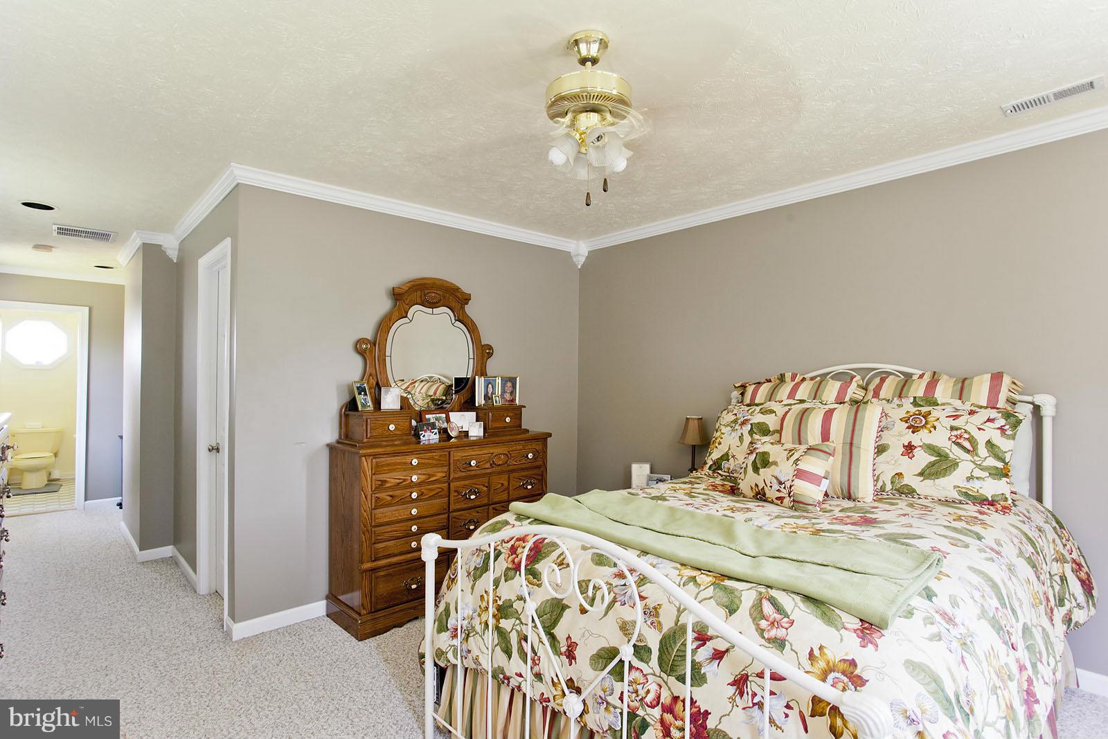 1209 Hollow Road Gore, VA 22637 - Photo 18 of 30 a bedroom with a bed and a chandelier