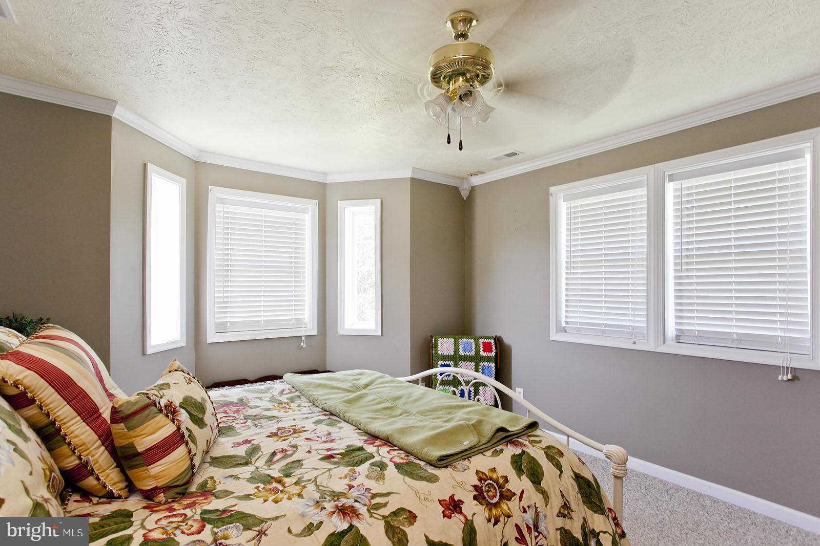 1209 Hollow Road Gore, VA 22637 - Photo 20 of 30 a bed sitting in a bedroom next to a window
