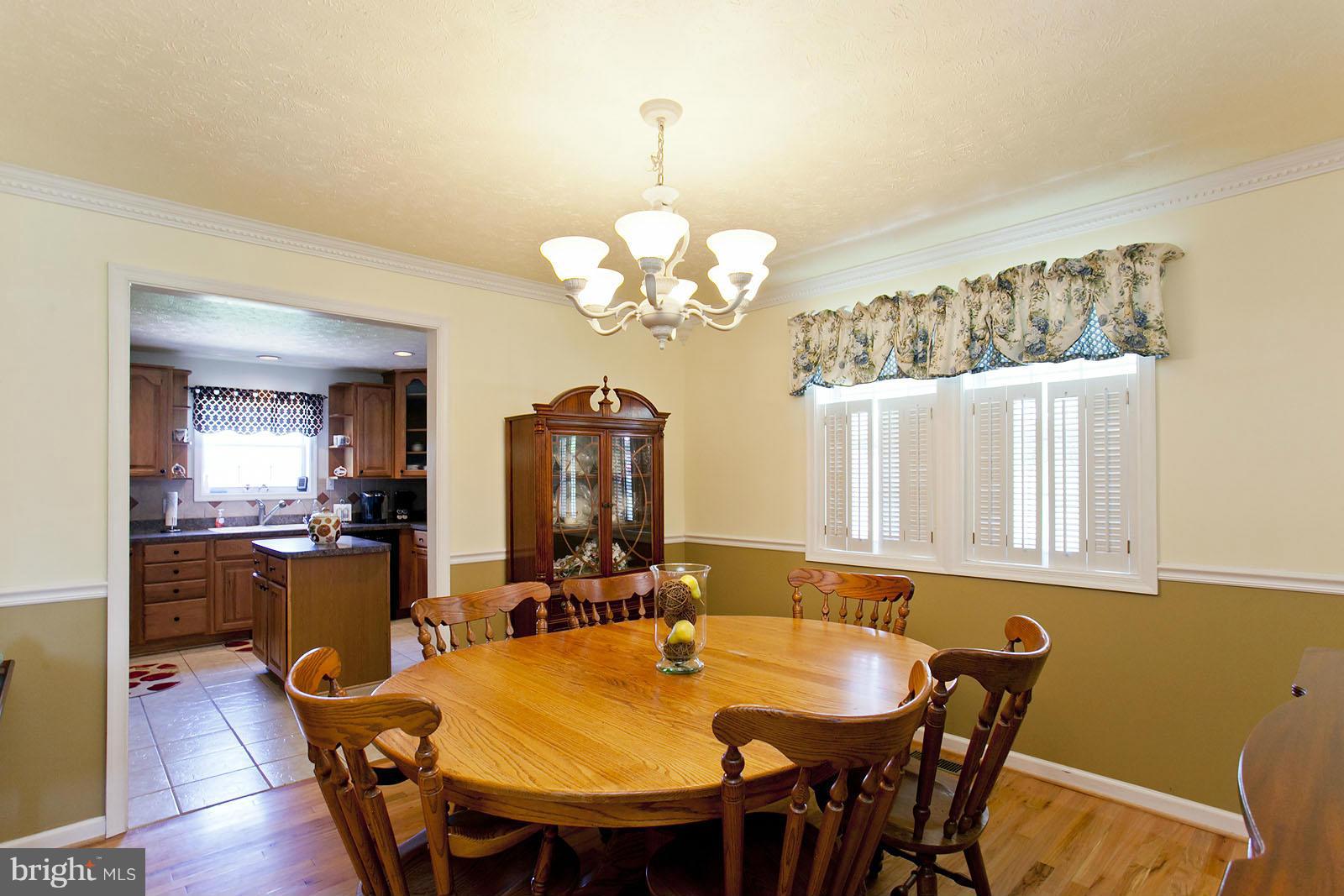 1209 Hollow Road Gore, VA 22637 - Photo 5 of 30 a view of a dining room with furniture and wooden floor