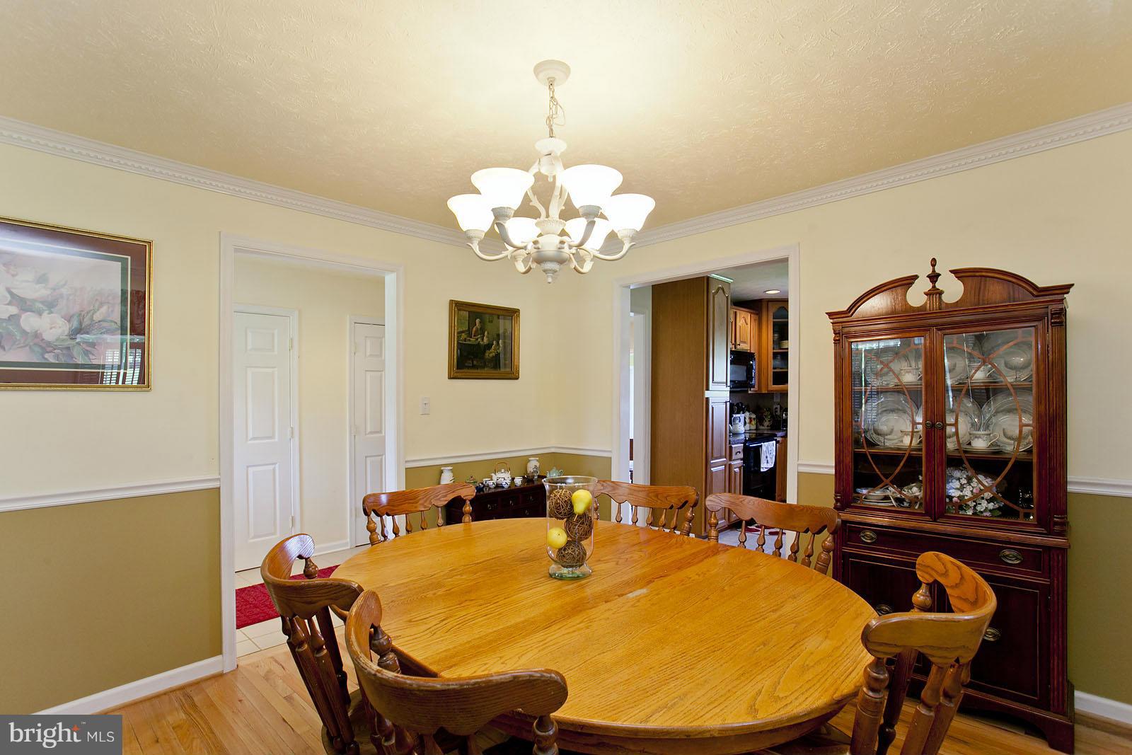 1209 Hollow Road Gore, VA 22637 - Photo 6 of 30 a view of a dining room with furniture and chandelier
