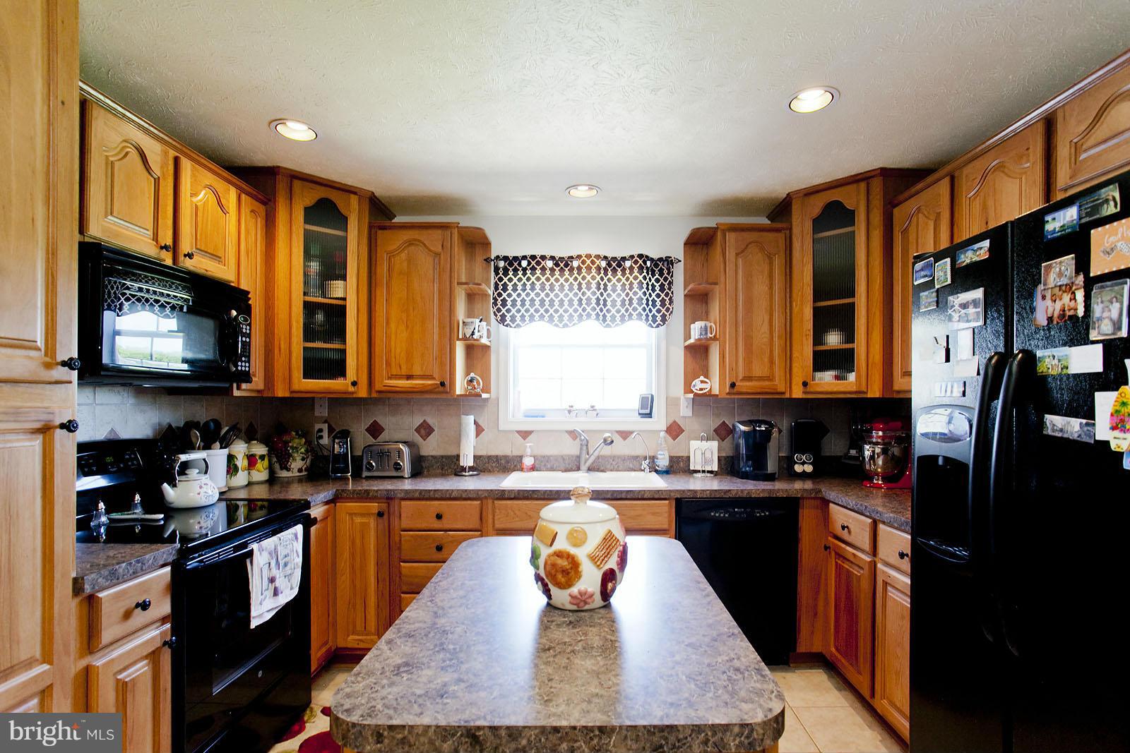 1209 Hollow Road Gore, VA 22637 - Photo 10 of 30 a large kitchen with stainless steel appliances granite countertop a stove a sink dishwasher and cabinets