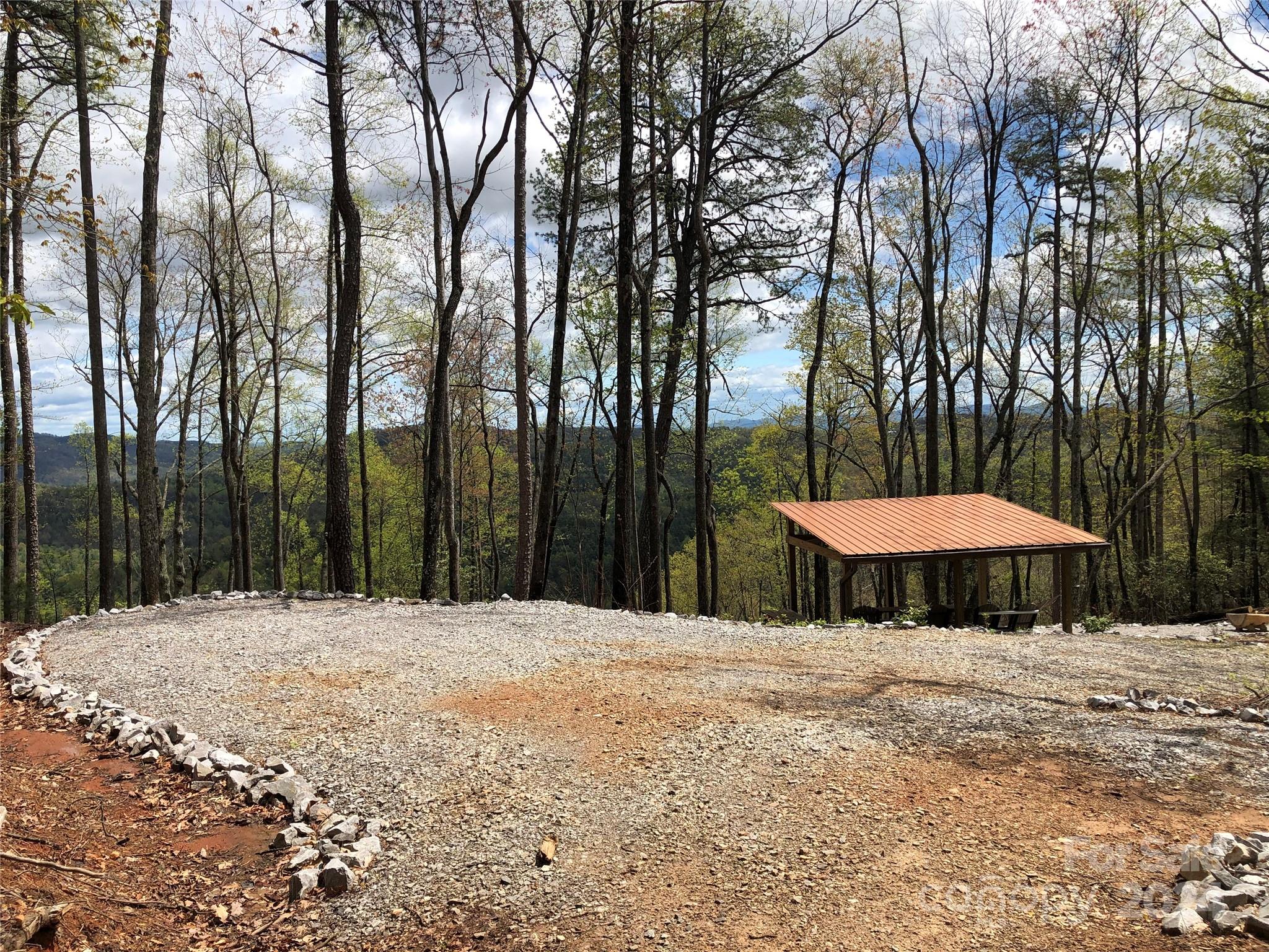 Tbd Wolf Pen Road, Unit 24 Purlear, NC 28665 - Photo 24 of 46 a swimming pool with a table and chairs under an umbrella