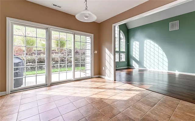a view of a backyard with couches plants and large tree