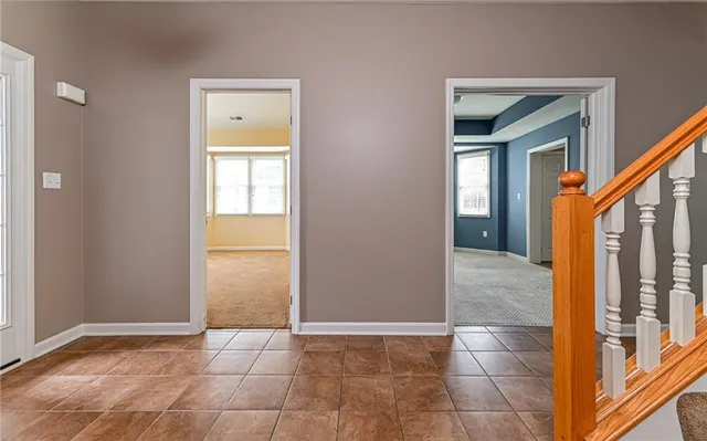 a kitchen with stainless steel appliances granite countertop a refrigerator a stove and a sink