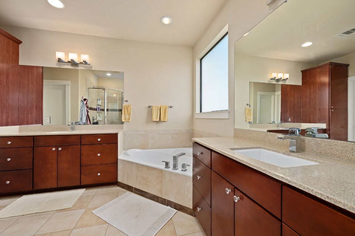 2819 Corbin Lane Austin, TX 78704 - Photo 13 of 22 a spacious bathroom with a granite countertop double vanity sink a mirror and a bathtub
