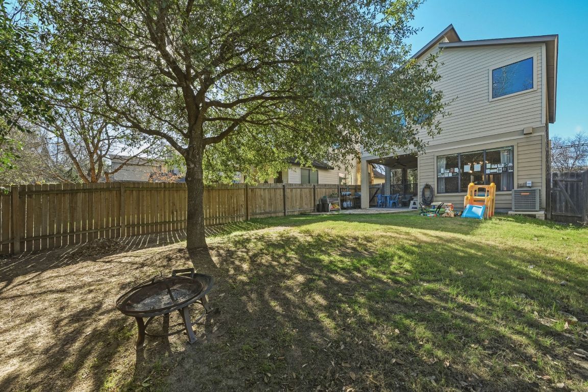 2819 Corbin Lane Austin, TX 78704 - Photo 21 of 22 a view of a backyard with large trees and wooden fence