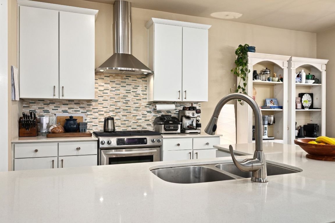 2819 Corbin Lane Austin, TX 78704 - Photo 3 of 22 a kitchen with granite countertop a sink a stove and cabinets
