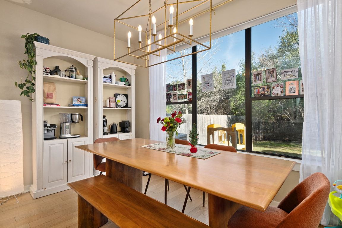2819 Corbin Lane Austin, TX 78704 - Photo 8 of 22 a view of a dining room with furniture a chandelier and a floor to ceiling window