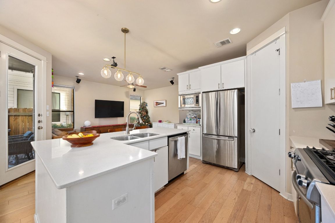 2819 Corbin Lane Austin, TX 78704 - Photo 9 of 22 a kitchen with refrigerator a sink and a stove