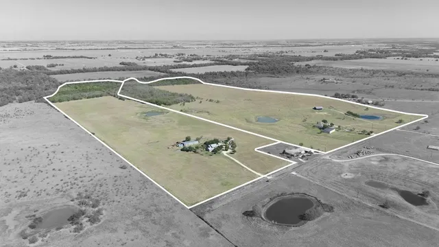 a view of a big yard with lots of green space