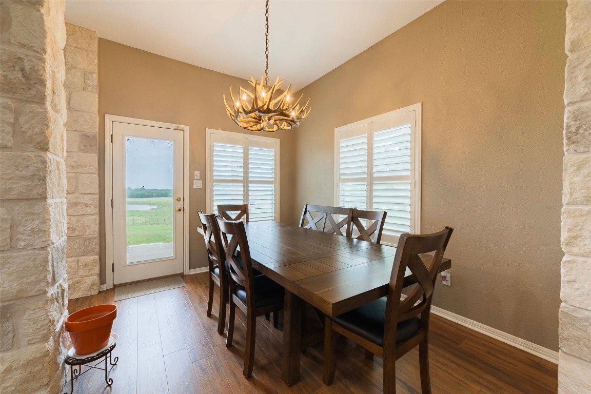 20145 Janak Road Coupland, TX 78615 - Photo 19 of 40 a view of a dining room with furniture window and wooden floor
