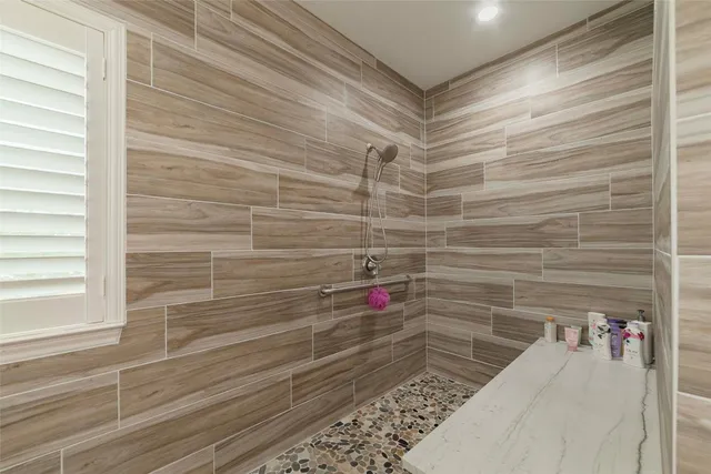 a bed sitting in a bedroom next to a window with a chandelier