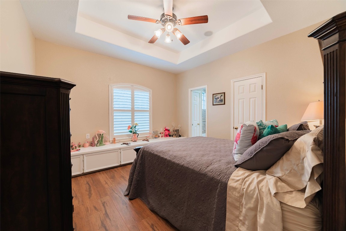 20145 Janak Road Coupland, TX 78615 - Photo 31 of 40 a bed room with a bed and a chandelier