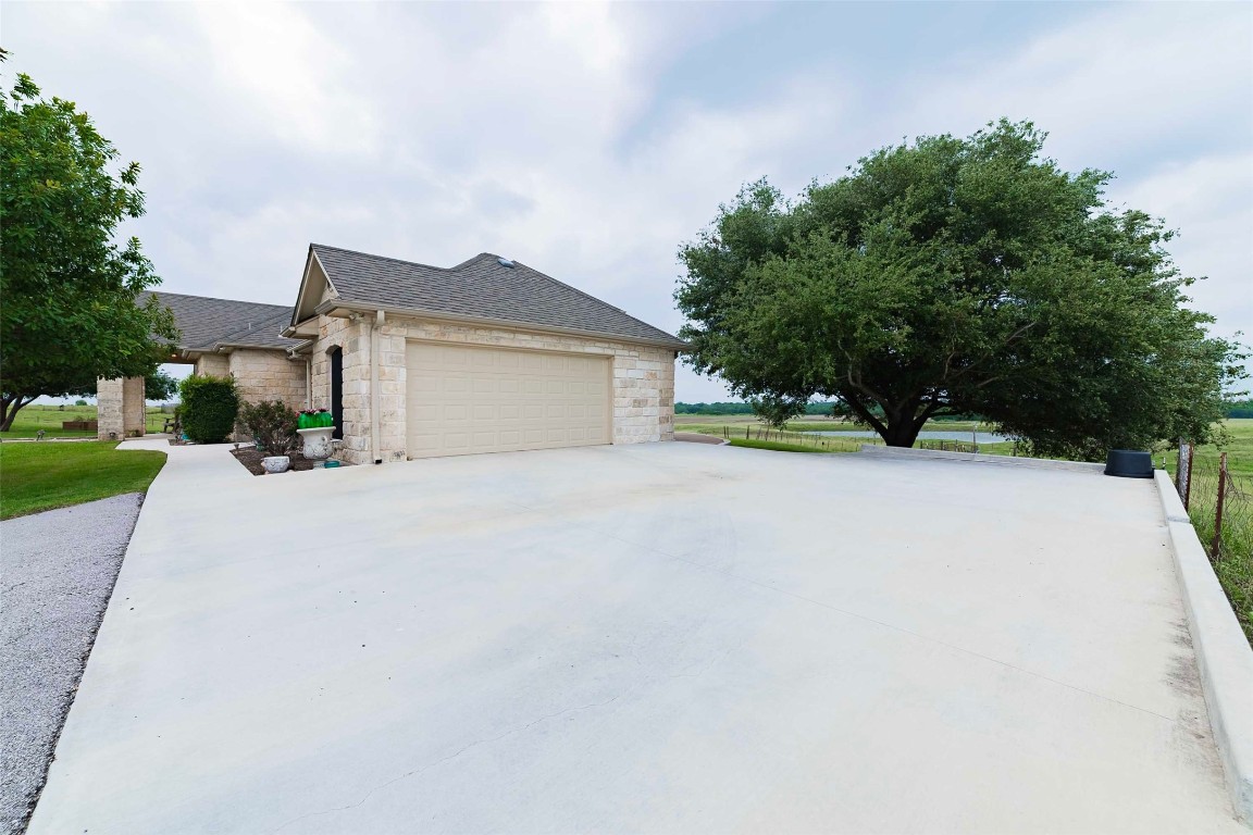 20145 Janak Road Coupland, TX 78615 - Photo 32 of 40 a front view of a house with a yard and garage