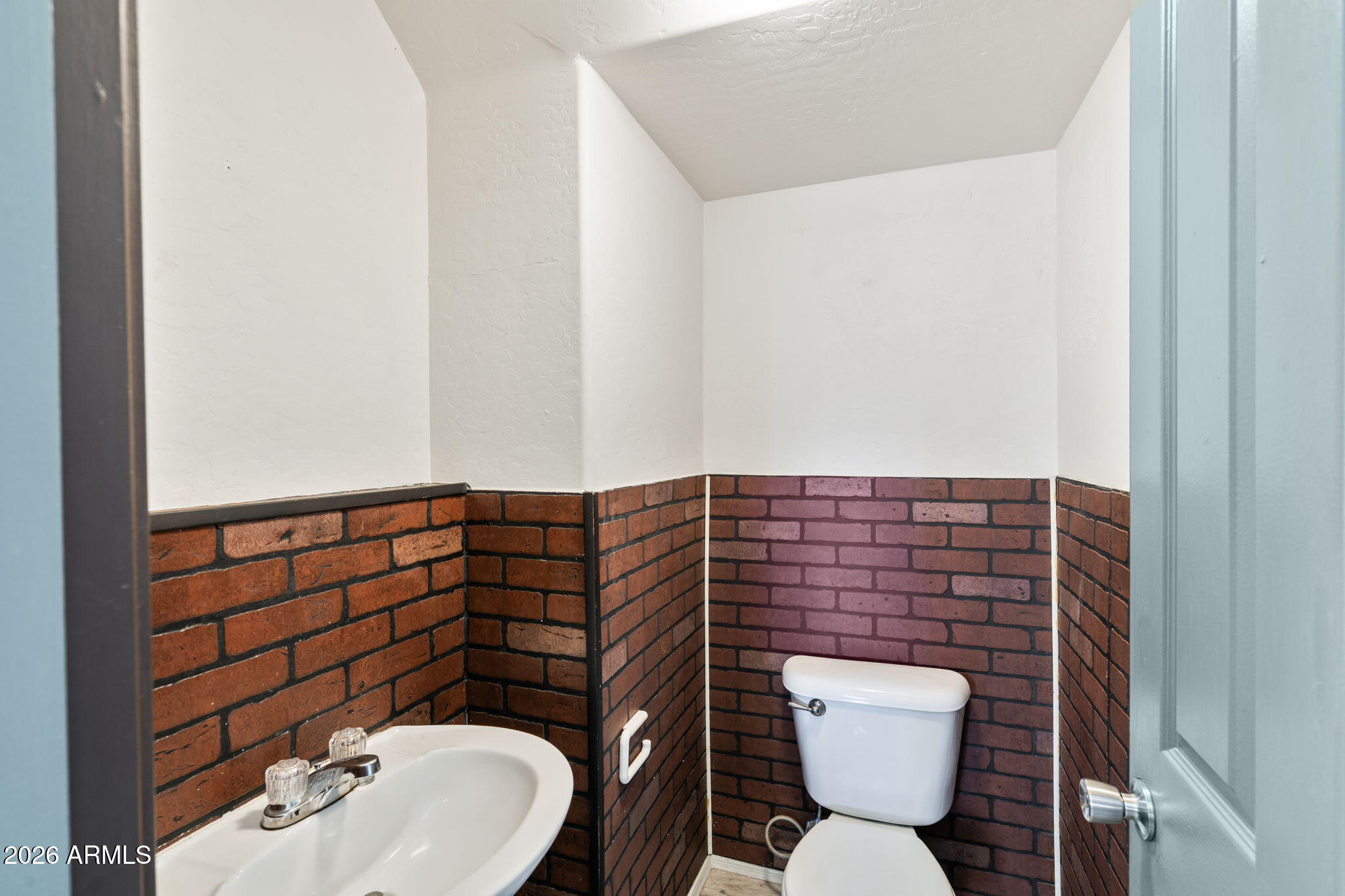 1332 East Dunbar Drive Phoenix, AZ 85042 - Photo 12 of 50 a bathroom with a toilet a sink and a mirror