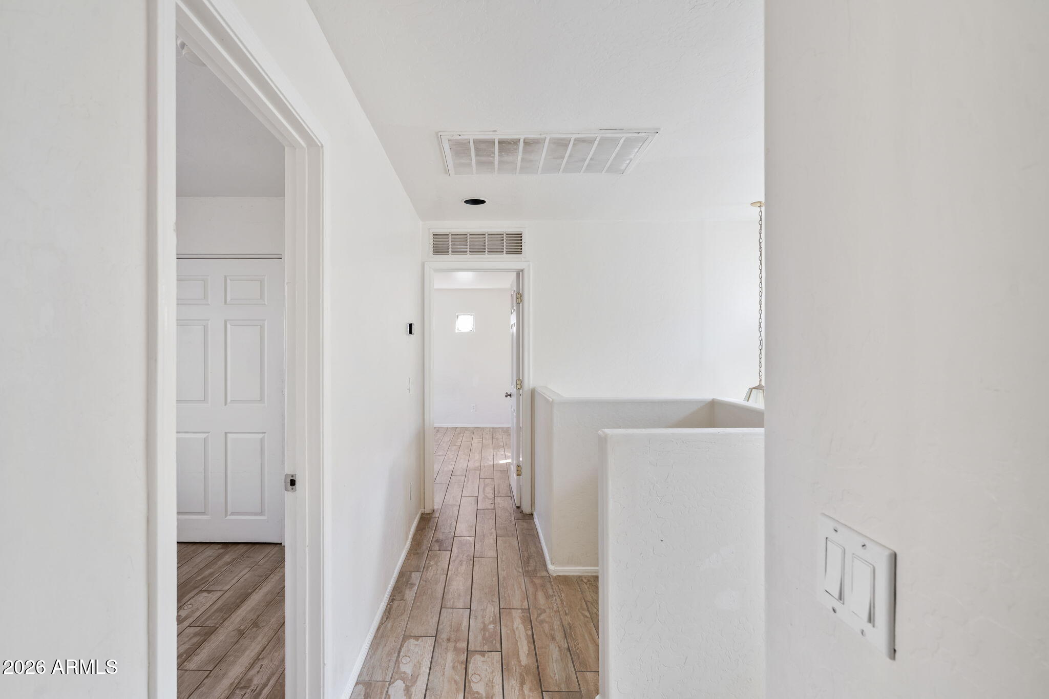 1332 East Dunbar Drive Phoenix, AZ 85042 - Photo 14 of 50 a view of a hallway with wooden floor