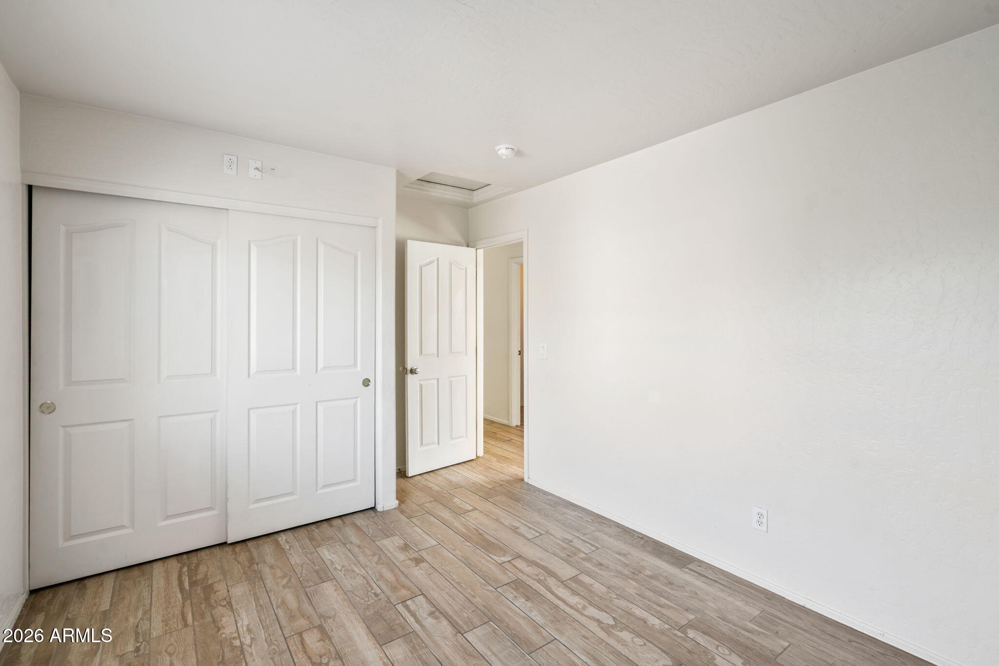 1332 East Dunbar Drive Phoenix, AZ 85042 - Photo 19 of 50 a view of an empty room with wooden floor