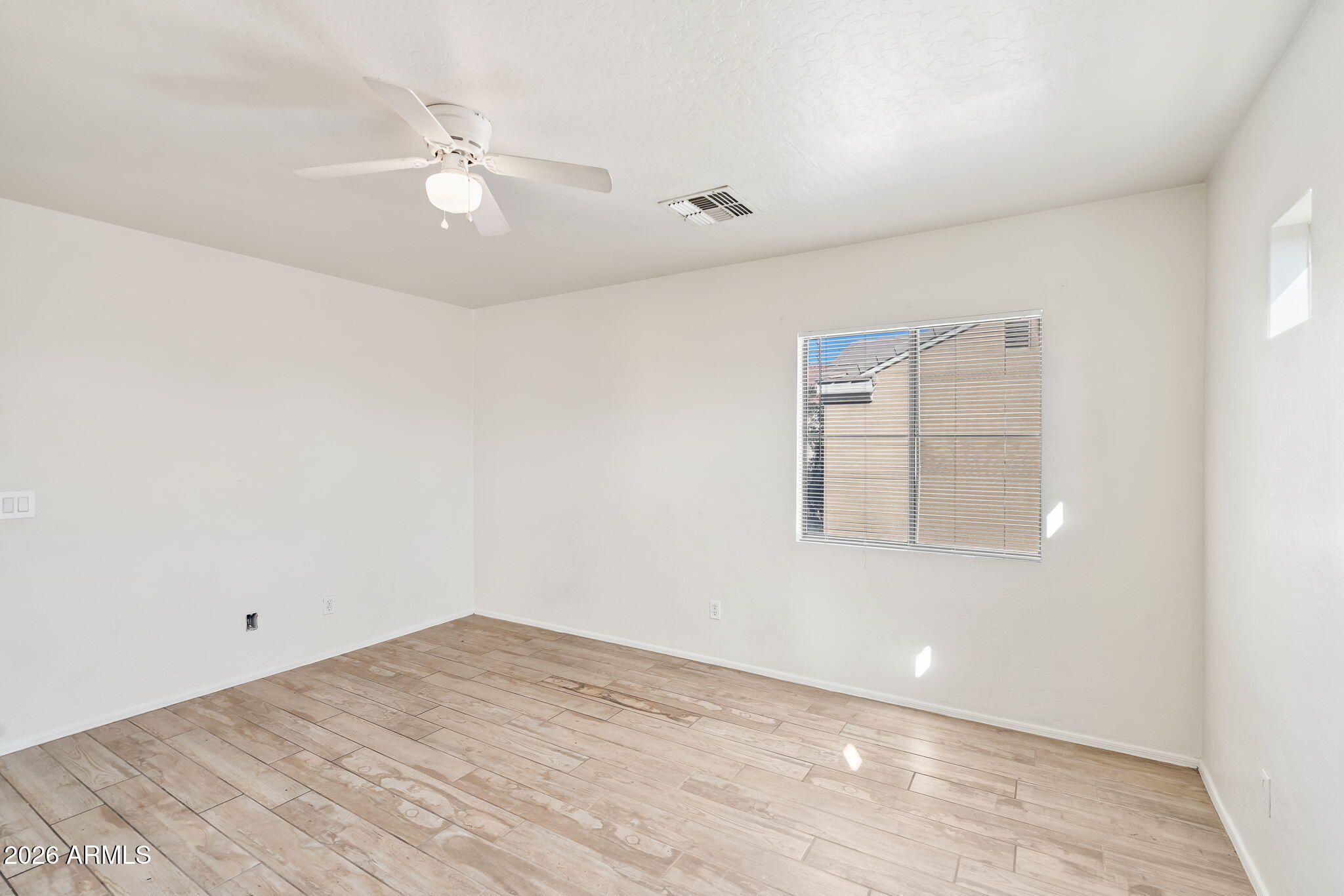 1332 East Dunbar Drive Phoenix, AZ 85042 - Photo 25 of 50 an empty room with chandelier fan and windows