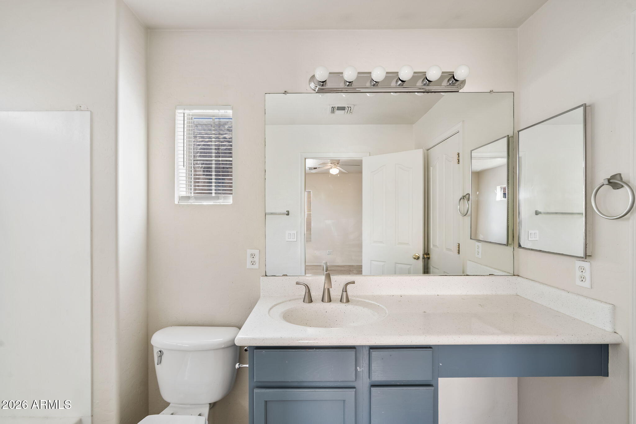 1332 East Dunbar Drive Phoenix, AZ 85042 - Photo 26 of 50 a bathroom with a sink a toilet and mirror