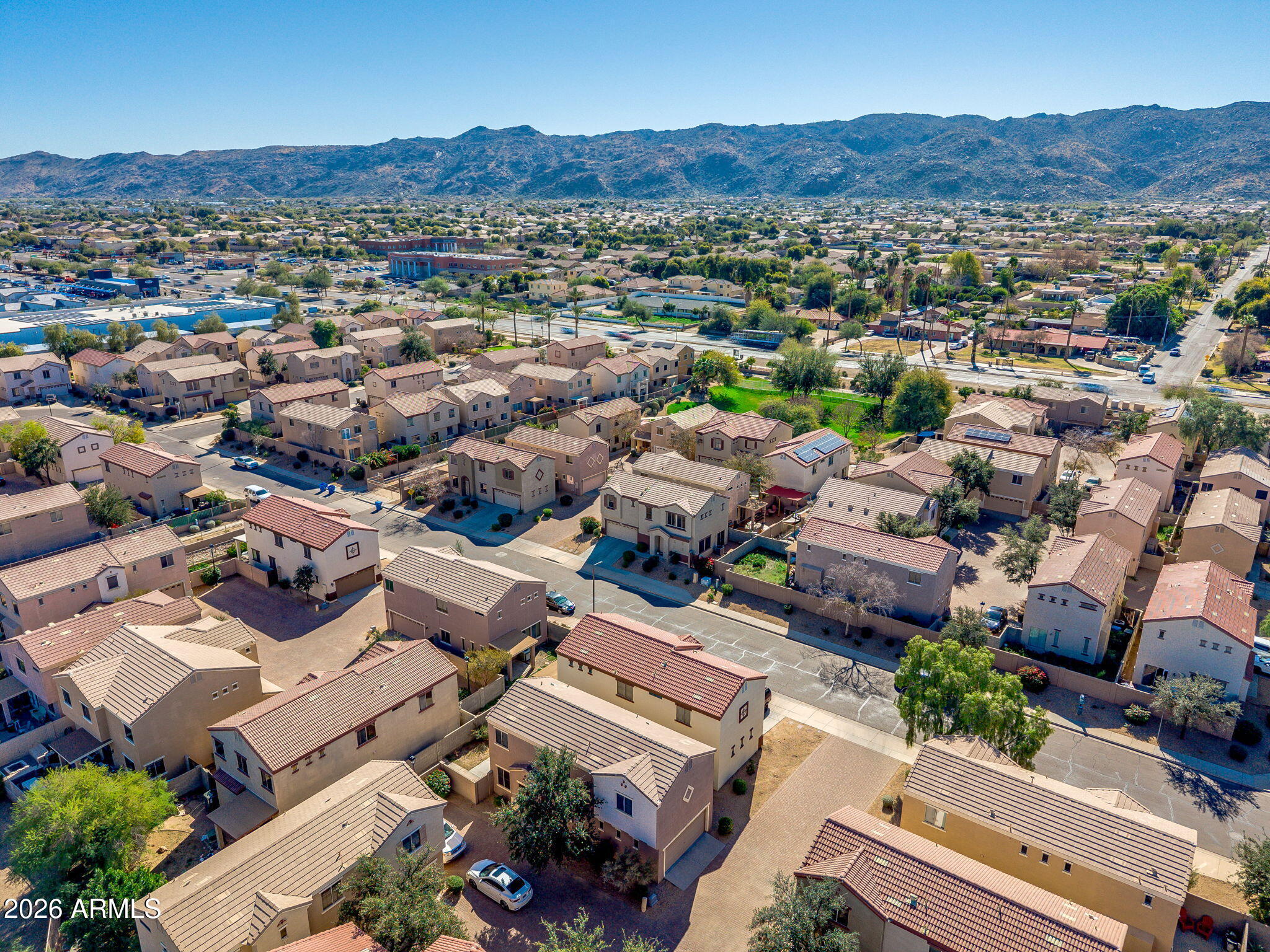 1332 East Dunbar Drive Phoenix, AZ 85042 - Photo 43 of 50 an aerial view of a city with lots of residential buildings and mountain view in back