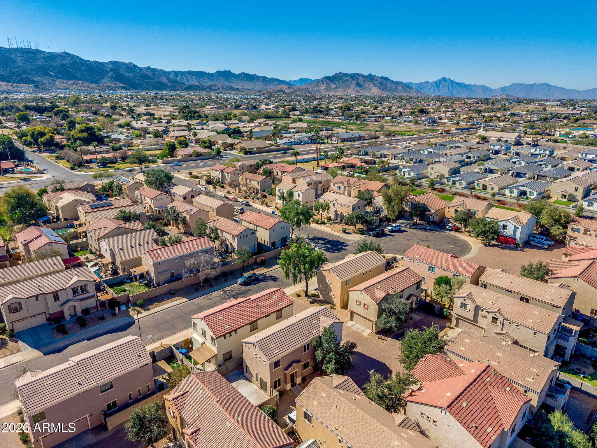 1332 East Dunbar Drive Phoenix, AZ 85042 - Photo 48 of 50 an aerial view of a city with lots of residential buildings and mountain view in back