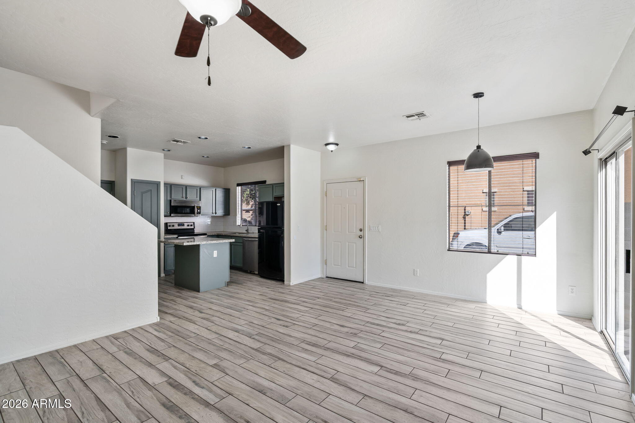 1332 East Dunbar Drive Phoenix, AZ 85042 - Photo 6 of 50 a view of a kitchen with a sink and dishwasher with wooden floor