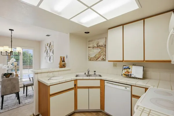 a kitchen with a sink cabinets and window