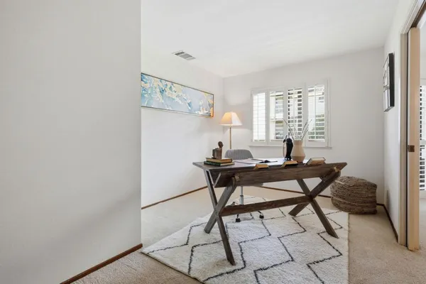 a view of a dining room with furniture and window