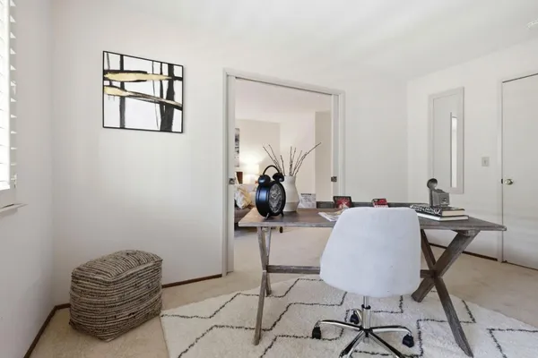 a room with gym equipment and windows