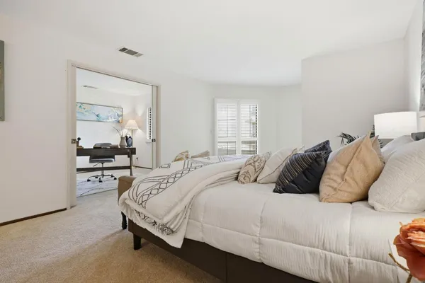 a bedroom with a bed and a dresser