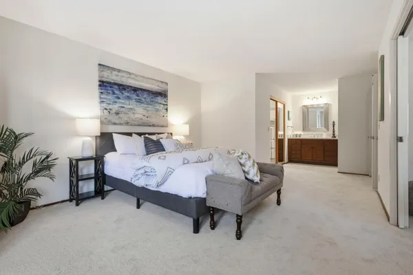 a bedroom with a bed and a table in it