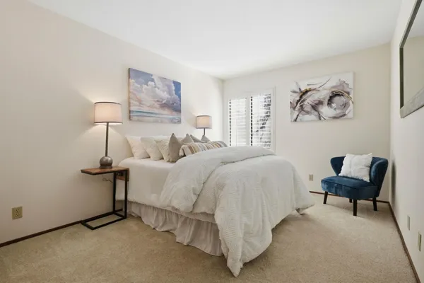 a bedroom with a bed and a lamp on table