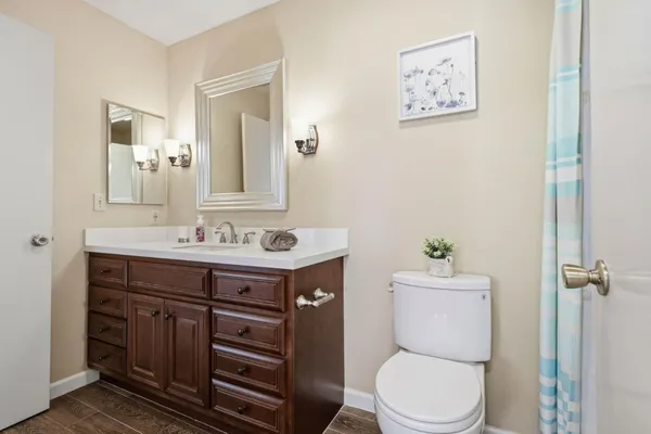 a bathroom with a sink a toilet and shower