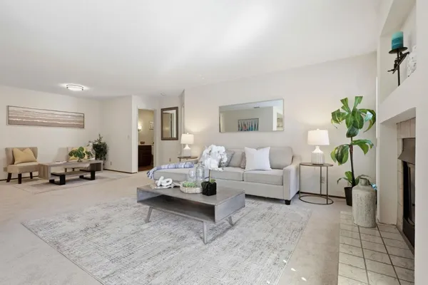 a living room with furniture and a potted plant