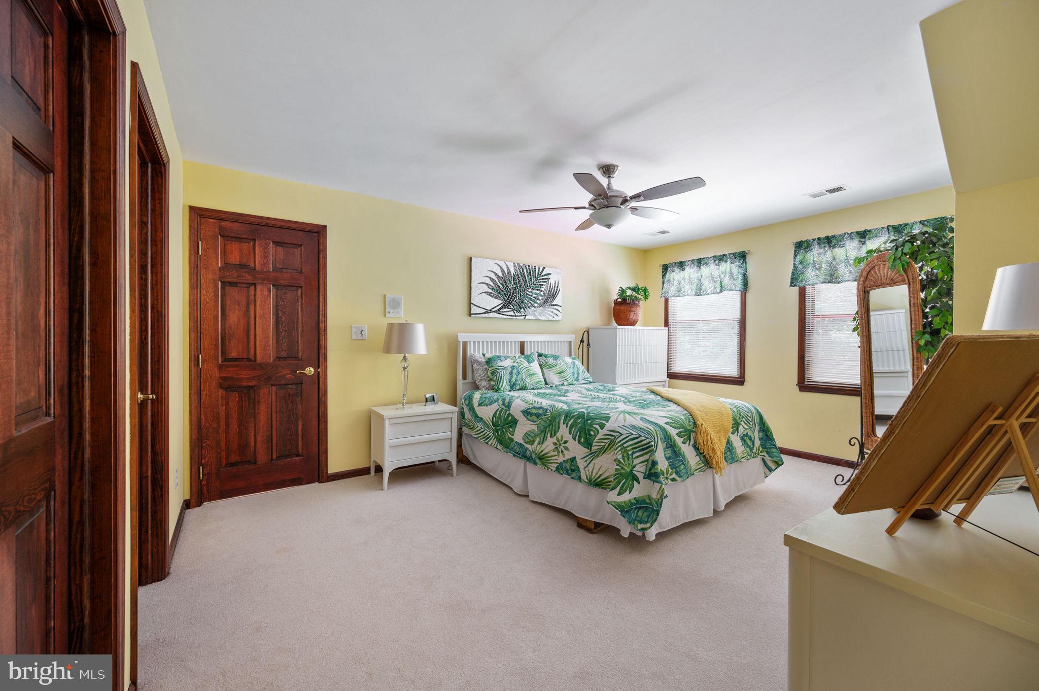 11105 Waddell Road Bumpass, VA 23024 - Photo 51 of 76 a spacious bedroom with a bed a dresser and a window