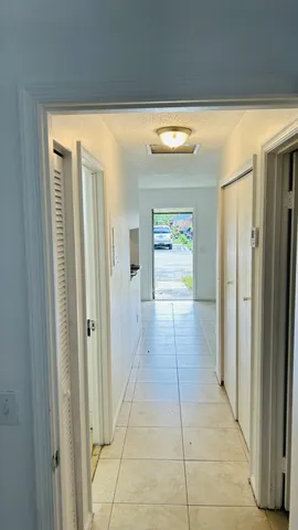 a view of a hallway with wooden shelves