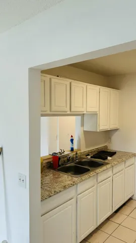 a kitchen with a sink and cabinets