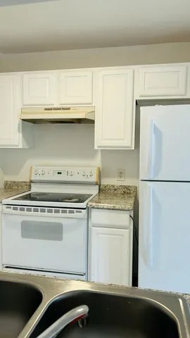 a stove top oven sitting inside of a kitchen