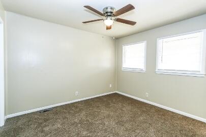 5408 31st Street Lubbock, TX 79407 - Photo 17 of 33 an empty room with a window and a fan