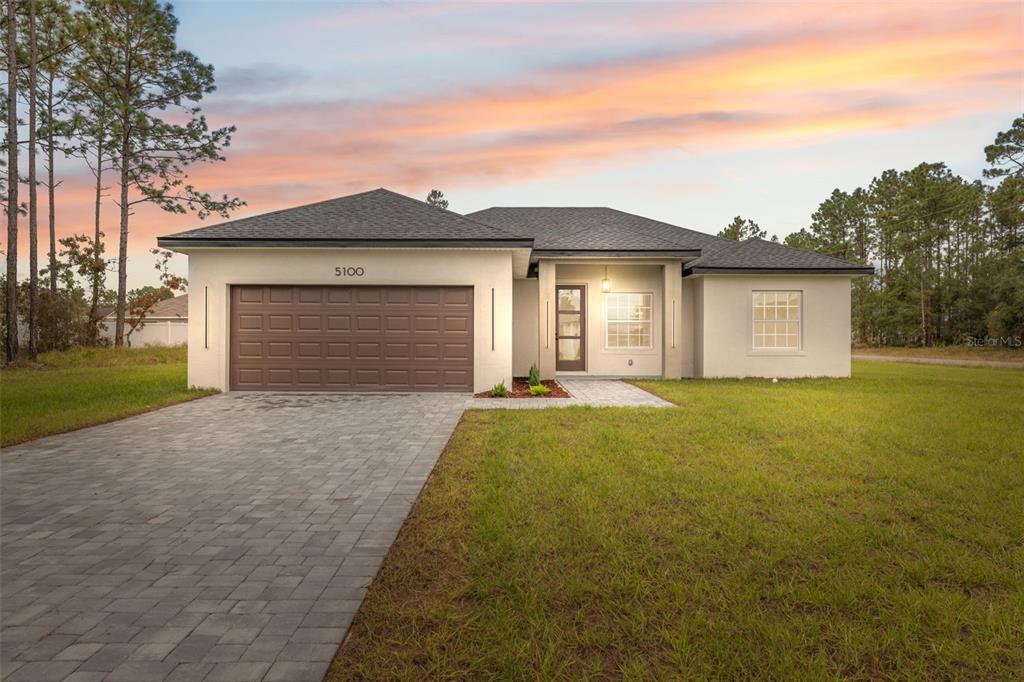 5100 Southwest 155th Loop Ocala, FL 34473 - Photo 1 of 1 a front view of a house with yard and trees
