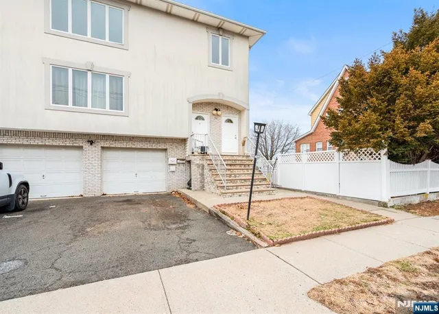 a front view of a house with parking