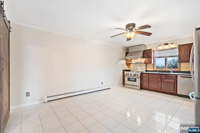 a kitchen with stainless steel appliances a refrigerator and cabinets