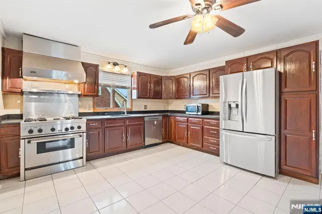 a kitchen with granite countertop stainless steel appliances and white cabinets