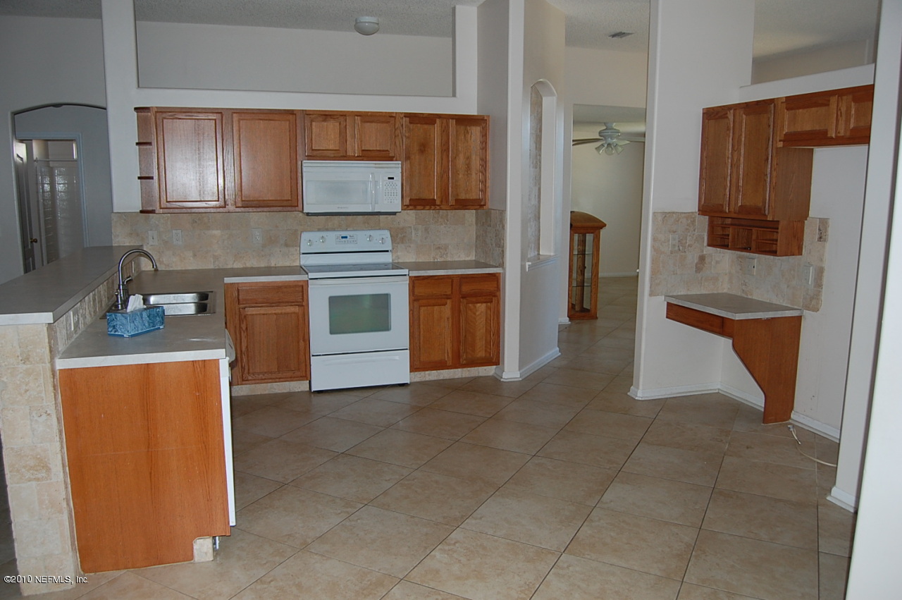 2444 Paris Mill Road Jacksonville, FL 32221 - Photo 5 of 19 a kitchen with stainless steel appliances granite countertop a refrigerator and a stove top oven