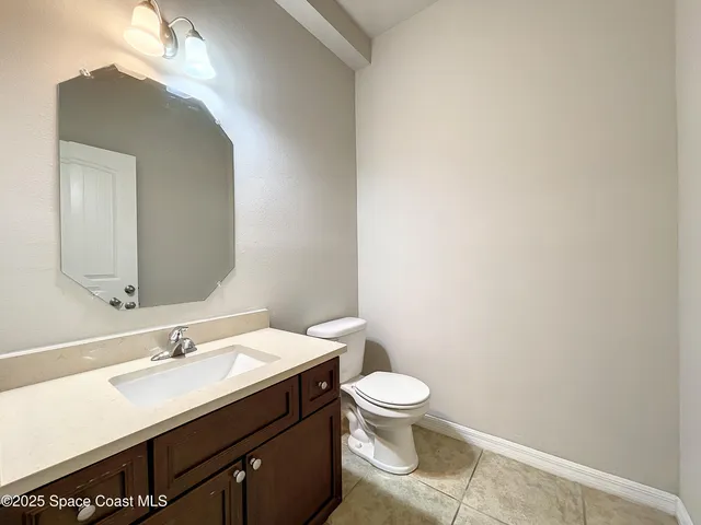 a bathroom with a sink vanity and a toilet
