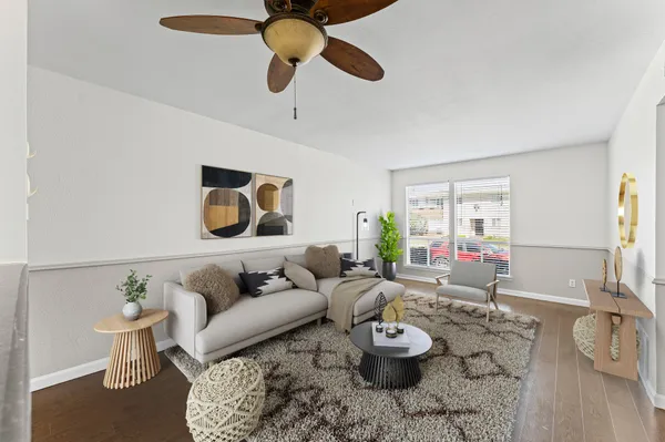 a living room with furniture and a wooden floor