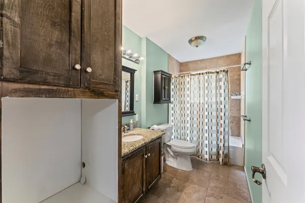 a bathroom with a double vanity sink toilet and shower